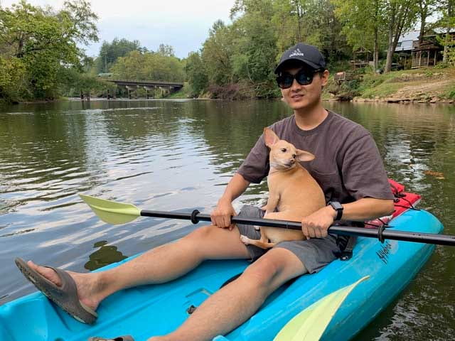 Jihnwan on kayak with dog